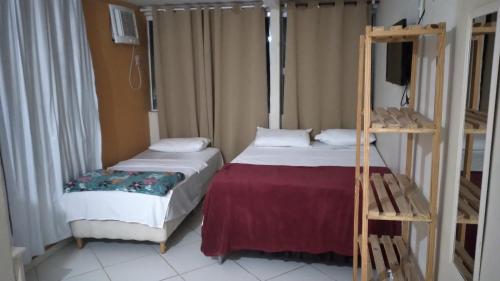 Una cama o camas en una habitación de Flats Vila Bela Búzios