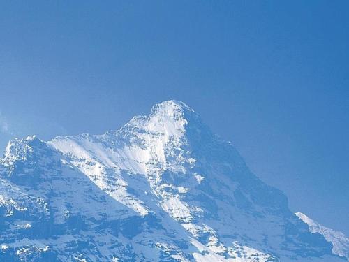 einen schneebedeckten Berg mit blauem Himmel in der Unterkunft alleinstehendes Ferienhaus in Grindelwald