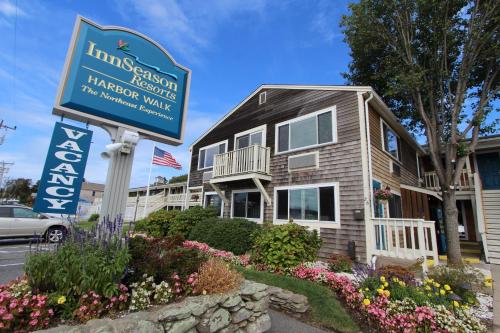 a sign in front of a house with flowers at InnSeason Resorts HarborWalk in Falmouth