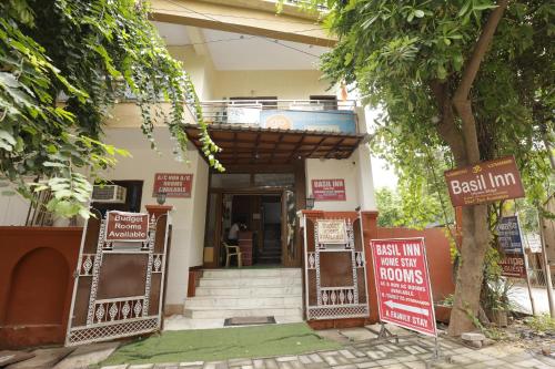 une maison avec des panneaux devant un bâtiment dans l'établissement Basil Inn Home Stay Walking Distance From Taj Mahal Agra, à Agra