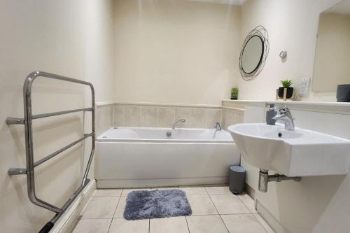 bagno con vasca bianca e lavandino di 2 bedroom apartment a Liverpool