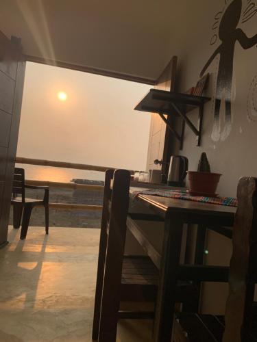 a dining room with a table and a view of the ocean at Tayta Surf House in Lobitos