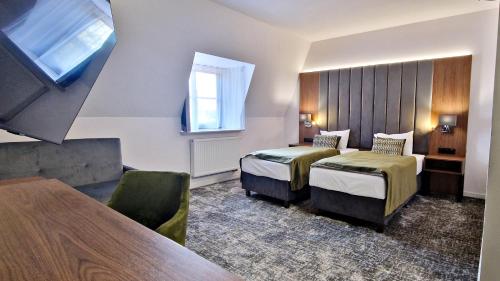 a hotel room with two beds and a window at Hotel Korona Spa & Wellness in Lublin