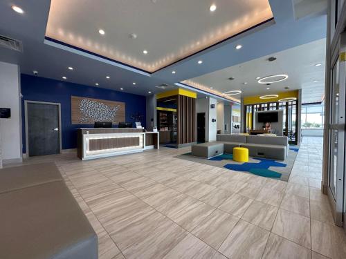 an office lobby with a reception desk and blue walls at Microtel Inn & Suites by Wyndham Amarillo West in Amarillo