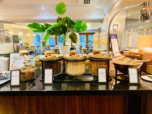 a counter with many different types of food in jars at Hilton Northampton Hotel in Northampton