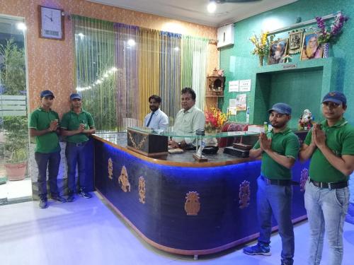 a group of men standing around a counter in a room at MAAN Hotel in Alwar