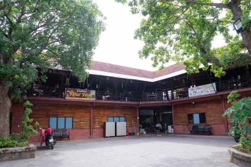 a building with people sitting on the balconies of it at Khách Sạn Như Mai in Quang Tri