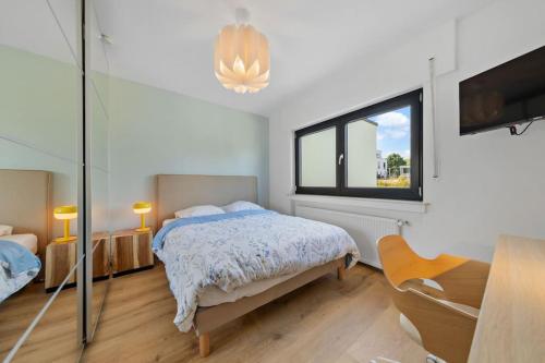 ein weißes Schlafzimmer mit einem Bett und einem Fenster in der Unterkunft Villa66 Private suite 3 in Livange