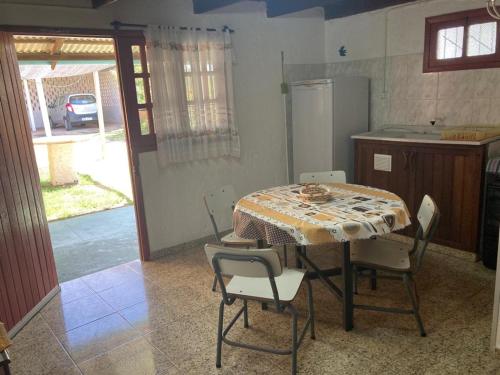 uma cozinha com mesa e cadeiras num quarto em Rochas em Barra del Chuy