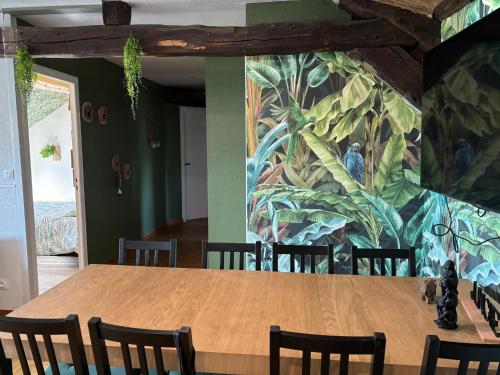 un comedor con una gran pintura en la pared en Jungle Cosy, en Louviers