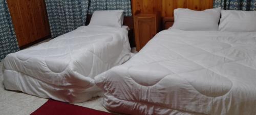 A bed or beds in a room at Kilimanjarocountry club