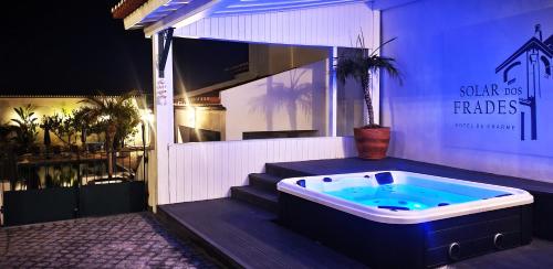 a jacuzzi tub sitting outside of a building at SOLAR DOS FRADES in Ferreira do Alentejo