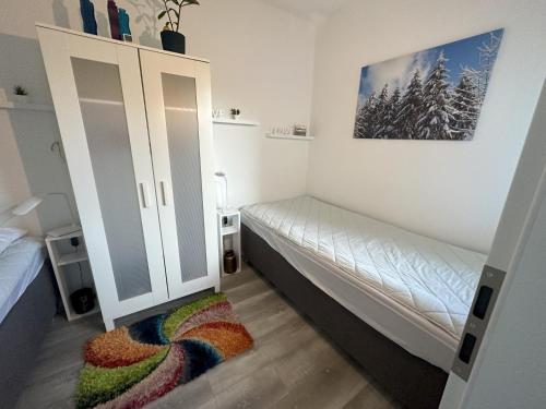 Rúm í herbergi á Moderne und komfortable Appartements im Ferienpark Hahnenklee