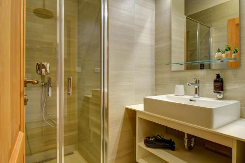 a bathroom with a sink and a shower at Hotel Karlova Prague in Prague