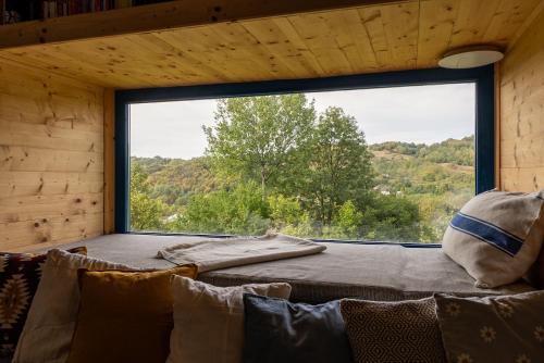 een kamer met een bank en een groot raam bij La sat - Radu Dragu in Bertea