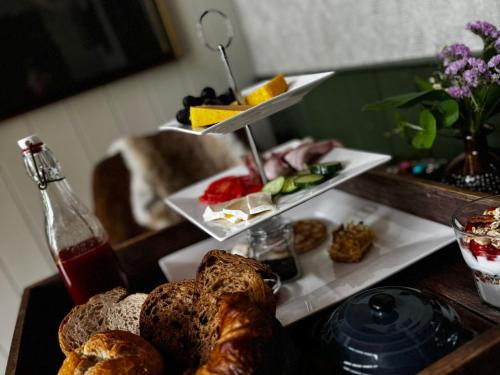 a table topped with bread and a plate of food at B&B 't Maartensdijkse Bos in Maartensdijk