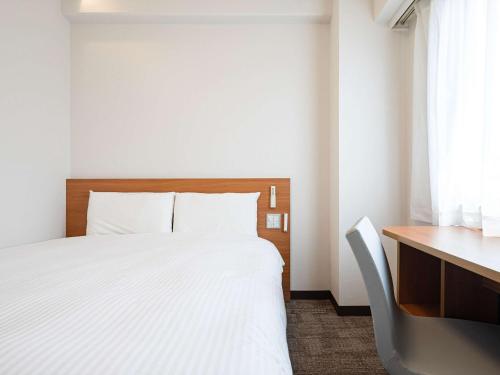 Comfort Inn Hitachinaka में एक कमरे में एक या कई बेड