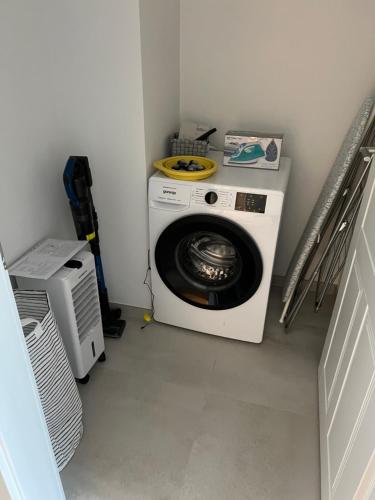 a washer and dryer sitting in a laundry room at CityLife InApartment Salzburg in Salzburg