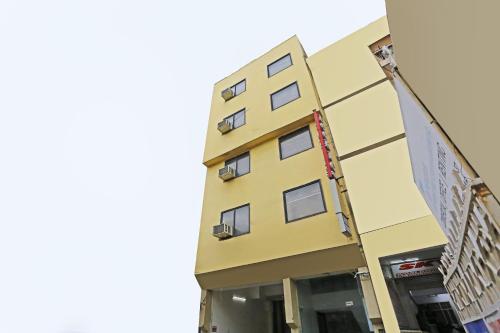 a yellow building with windows on the side of it at Iconic Inn Near Delhi IGI Airport in New Delhi