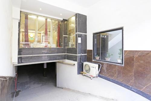 a bathroom with a sink and a mirror on the wall at Iconic Inn Near Delhi IGI Airport in New Delhi