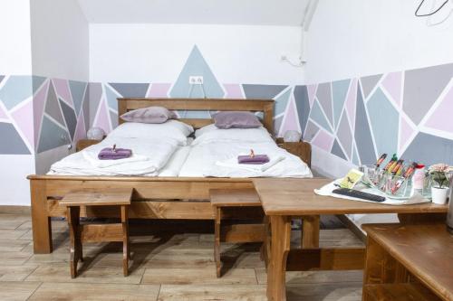 a bedroom with a bed and a wooden table at Air&Day in Vecsés