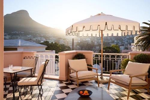 ケープタウンにあるMount Nelson, A Belmond Hotel, Cape Townのバルコニー(椅子、テーブル、パラソル付)