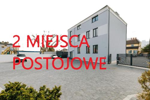 a large white building with the words mestica posado at Obiekt Noclegowy OCELOT II in Pruszków