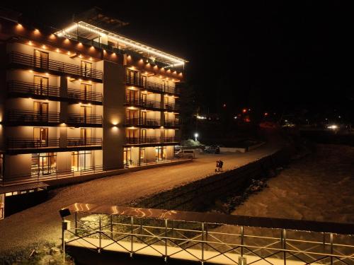 un edificio con luces encendidas por la noche en Hotel Ushba in Mestia, en Mestia