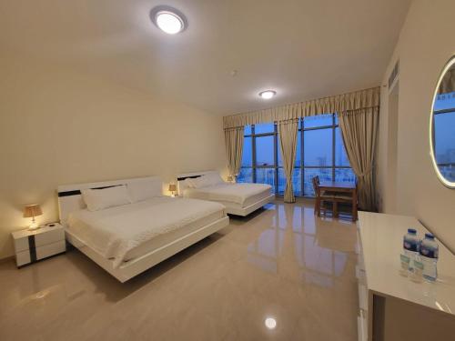 A bed or beds in a room at Sunset Sea view Furnish Apartment