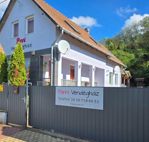 a house with a fence in front of it at Panni Vendégház in Egerszalók