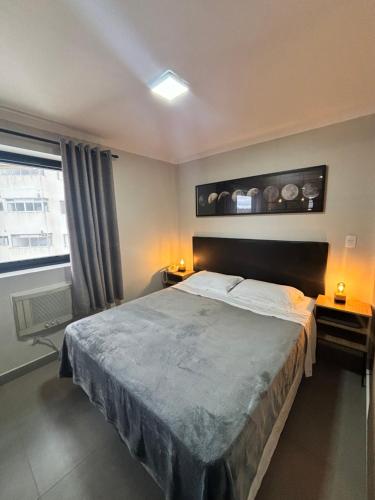 a bedroom with a large bed and a window at Flat Luxuoso Biena Sena Madureira Vila Mariana com garagem 1009 in Sao Paulo