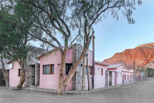 a street in a town with pink buildings at Nido de cóndores in Purmamarca