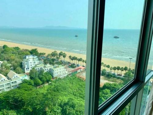 a view from a window of the beach and ocean at 1bedroom seaview ห้องวิวทะเล ชั้น28 premium highfloorวิ in Jomtien Beach