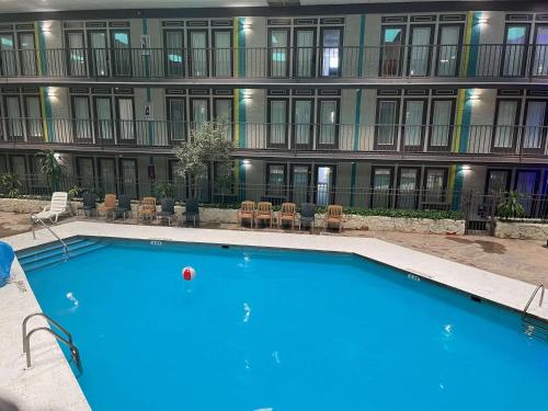 a large swimming pool in front of a building at Studio 6 Suites Amarillo, TX West Medical Center in Amarillo