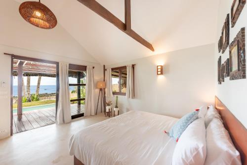 A bed or beds in a room at Rare Beachfront Villa - 2BR - 6 Pax Private Pool on Tuason Surf Spot