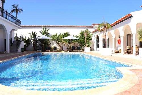 a swimming pool in the middle of a house at SOLAR DOS FRADES in Ferreira do Alentejo