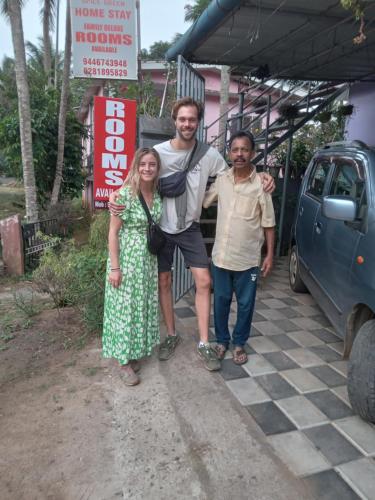 a man and a woman standing next to a car at SpiceGreen Homestay,Thekkady in Thekkady