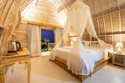 um quarto com uma cama e uma rede mosquiteira em Wijaya Cottage Nusa Penida em Nusa Penida