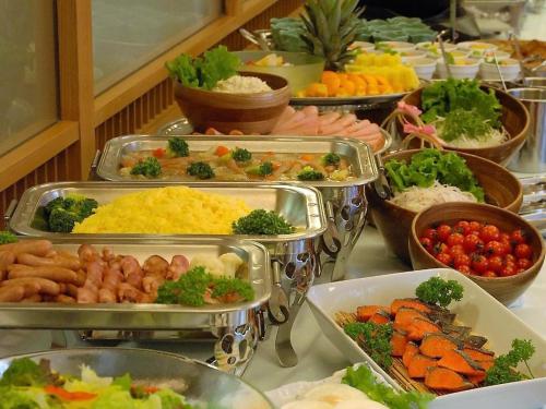 a buffet with many trays of different types of food at Albert Hotel in Akita