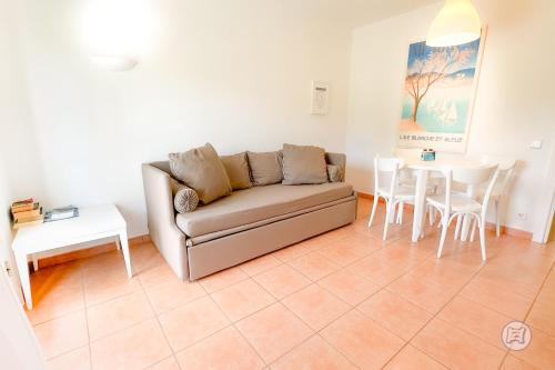 a living room with a couch and a table at The Desmais in Cala Galdana