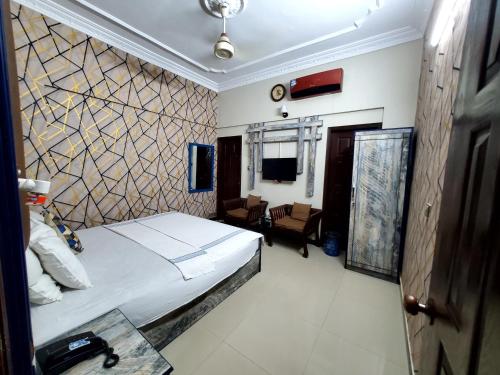 a bedroom with a large bed in a room at Diplomat Inn Hotel in Karachi