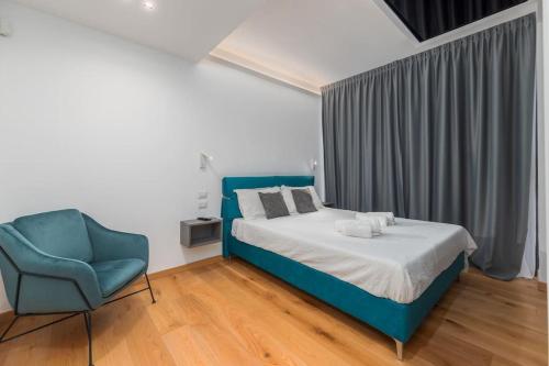 um quarto com uma cama e uma cadeira azul em Spa Privata Luxury Apartment 5stelle-Free Parking em Monza