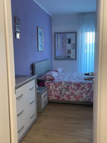 een kleine slaapkamer met een bed en een dressoir bij A casa di Sara in Ostia Antica