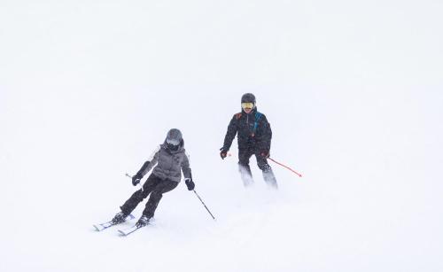 duas pessoas a esquiar numa encosta coberta de neve em RVHotels Tuca em Vielha