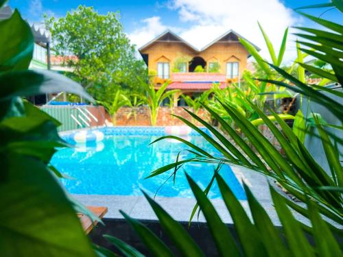 a house with a swimming pool in front of a house at An Nam Ơi House Homestay in Tam Coc in Vũ Lâm