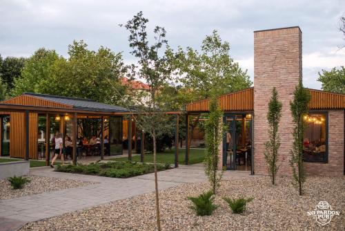 a rendering of a building with people in a park at No Pardon Hotel in Satu Mare