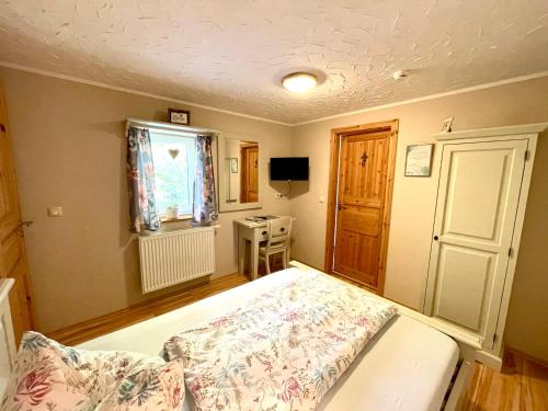 a bedroom with a bed and a window at Land & Leben Pension in Chemnitz