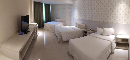 Tempat tidur dalam kamar di Nobile Hotel Convention Ciudad Del Este