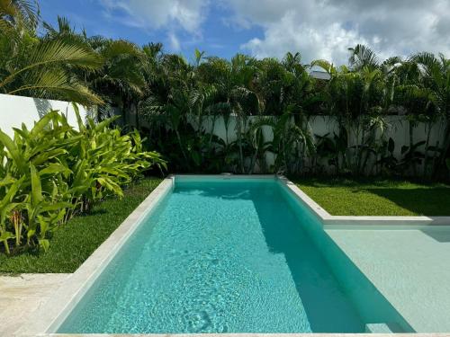 a blue swimming pool in a yard with palm trees at Tropical Pool Villa near Fishermans Village in Bophut 