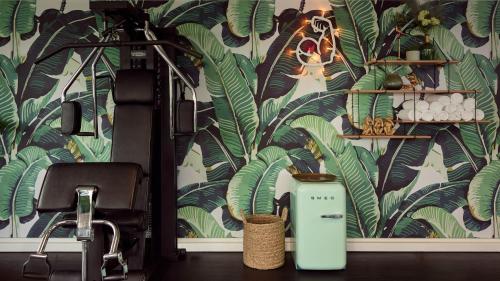 a bathroom with a wall with a tropical wallpaper at Van der Valk Hotel Brussels Airport in Diegem